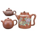 THREE CHINESE YIXING POTTERY TEA POTS. The first with glazed floral decoration, with four-