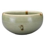 A CHINESE LONGQUAN CELADON AND IRON-SPOT POTTERY TEA BOWL. With deep rounded sides covered in a