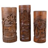 THREE CHINESE BAMBOO BRUSH POTS, 19TH CENTURY. Each carved in relief with scenes of figures in