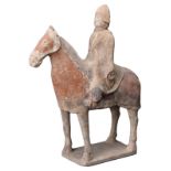 A CHINESE PAINTED POTTERY FIGURE OF ARMOURED HORSE AND RIDER, NORTHERN QI DYNASTY (550 - 577). The
