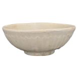 A CHINESE CIZHOU WHITE-GLAZED POTTERY CHRYSANTHEMUM BOWL, SONG DYNASTY. With rounded sides and