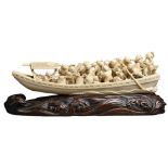 A JAPANESE SIGNED IVOVY OKIMONO OF MERCHANTS ON BOAT, MEIJI PERIOD. Well carved with various figures