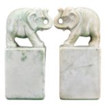 PAIR OF ASIAN CARVED SOAPSTONE BOOKENDS, 19/20TH CENTURY. The elephants stood with their trunks up