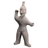 A GREY POTTERY FIGURE OF A WARRIOR, WESTERN JIN DYNASTY (265-317). The figure standing in a throwing