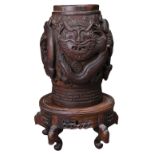 A SOUTHEAST ASIAN CARVED WOOD TOBACCO JAR ON STAND. The jar carved in deep relief with dragons and