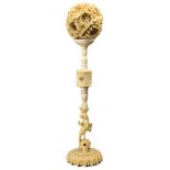 A CHINESE CARVED IVORY PUZZLE BALL ON STAND, 19TH CENTURY. The segmented stand with carved phoenix