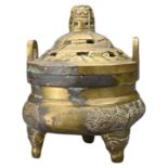 A CHINESE BRONZE TRIPOD CENSER AND COVER. The incense burner on three mask form legs with two looped