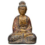 A CHINESE GILT-LACQUERED BRONZE FIGURE OF SEATED BUDDHA. Seated in meditation in robe decorated with