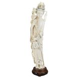 A TALL CHINESE CARVED IVORY FIGURE OF GUANYIN. The figure ornately carved dressed in flowing robes