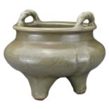 A CHINESE LONGQUAN CELADON TRIPOD CENSER. Thickly-potted with carved floral decoration to the body