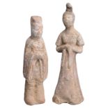 TWO CHINESE POTTERY FIGURES OF ATTENDANTS, TANG DYNASTY (618-907). To include a male and female