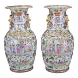 PAIR OF CHINESE CANTON FAMILLE ROSE PORCELAIN VASES, 19TH CENTURY. Decorated with ladies in