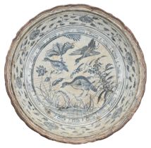 A LARGE VIETNAMESE BLUE AND WHITE CERAMIC DISH, 16TH CENTURY. The deep heavily-potted bracket