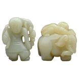 TWO CELADON JADE CARVINGS. To include an elephant with a boy on its back and a boy holding a lotus