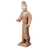 A LARGE CHINESE POTTERY FIGURE OF A GROOM, TANG DYNASTY (618-907). The tall standing figure