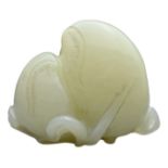 A CHINESE PALE CELADON JADE CARVING OF PEACHES. Carved in relief with two beaches sat on a leafy