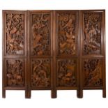 A LARGE CHINESE CAMPHOR WOOD FOUR-PANEL FOLDING SCREEN, 19/20TH CENTURY. Carved to the front
