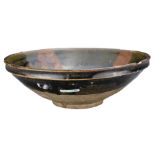 A CHNESE RUSSET-SPLASHED BLACK GLAZE POTTERY BOWL, JIN DYNASTY (1115-1234). With wide flaring