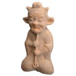 A CHINESE RED POTTERY FIGURE OF A SHAMAN, HAN DYNASTY (206BC-220AD). The tomb guardian figure with