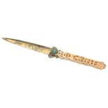 A CHINESE BRASS LETTER OPENER, 19/20TH CENTURY. With pierced ivory handle and inlaid jade stone.