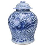 A CHINESE BLUE AND WHITE PORCELAIN PHOENIX JAR AND COVER, 18TH CENTURY. Covered in a scale pattern