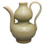 A CHINESE LONGQUAN CELADON EWER. Of double gourd form with a curved incised handle and spout covered