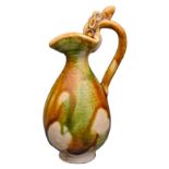 A CHINESE SANCAI GLAZED MINIATURE EWER. The pear shaped body with pinched spout and curved dragon