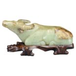 A CHINESE JADE CARVING OF RECUMBENT WATER BUFFALO. The celadon and russet jade carving of water