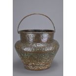 AN ANTIQUE MIDDLE EASTERN COPPER REPOUSSE CONTAINER