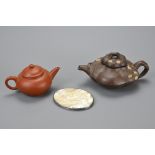 TWO CHINESE YIXING POTTERY TEA POTS AND MOTHER OF PEARL COVER. Mother of pearl and white metal