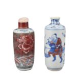 TWO CHINESE UNDERGLAZE BLUE AND COPPER RED PORCELAIN SNUFF BOTTLES, QING DYNASTY. Both of