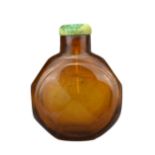 AN AMBER FACETED GLASS SNUFF BOTTLE, QING DYNASTY. The amber coloured transparent glass in octagonal