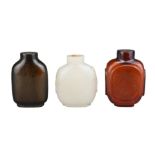 THREE CHINESE COLOURED GLASS SNUFF BOTTLES. Each of various forms. 5-5.5cm tall. (3) Provenance: