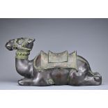 A LARGE INDIAN CAST BRONZE FIGURE OF A RECUMBENT CAMEL. Heavy and hollow cast figure facing