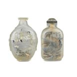 TWO CHINESE INSIDE-PAINTED GLASS SNUFF BOTTLES. A flattened cut glass bottle with mask handles