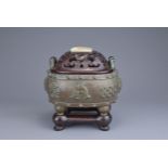 A CHINESE BRONZE BAJIXIANG CENSER AND COVER. Of drum shape with raised rope twist handles on four