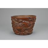 A CHINESE CARVED BAMBOO LIBATION CUP, 17/18TH CENTURY. Carved in relief with bird eating pomegranate