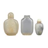 THREE CHINESE SNUFF BOTTLES, QING DYNASTY. Comprising a flattened clear rock crystal bottle; a