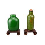 TWO CHINESE GLASS SNUFF BOTTLES, QING DYNASTY. To include a gold-splashed green glass cylindrical