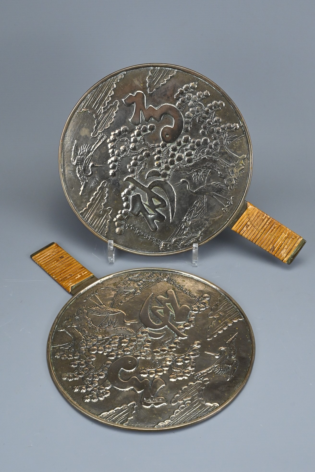 TWO JAPANESE POLISHED BRONZE HAND MIRRORS, KAGAMI, LATE 19TH CENTURY. Decorated with cranes under - Image 3 of 5