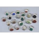 TWENTY WHITE METAL ISLAMIC SEAL RINGS. With various figurative and animal carved stone inserts (