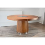 A CIRCULAR WOOD TABLE, 20TH CENTURY. The top with spinning glass insert over a strip of interior LED