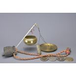 A GROUP OF SOUTH-EAST ASIAN BRONZE AND BRASS ITEMS. To include a cow bell on rope, a singing bowl, a