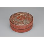 A CHINESE CINNABAR LACQUER INK BOX AND COVER, QING DYNASTY. Of cylindrical form carved with scholars