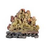 A CHINESE SOAPSTONE CARVING OF EIGHT IMMORTALS, QING DYNASTY. Well-carved with figures on rock