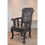 A CHINESE HARDWOOD ARMCHAIR, 19TH CENTURY. Heavily carved throughout with carved and pierced back