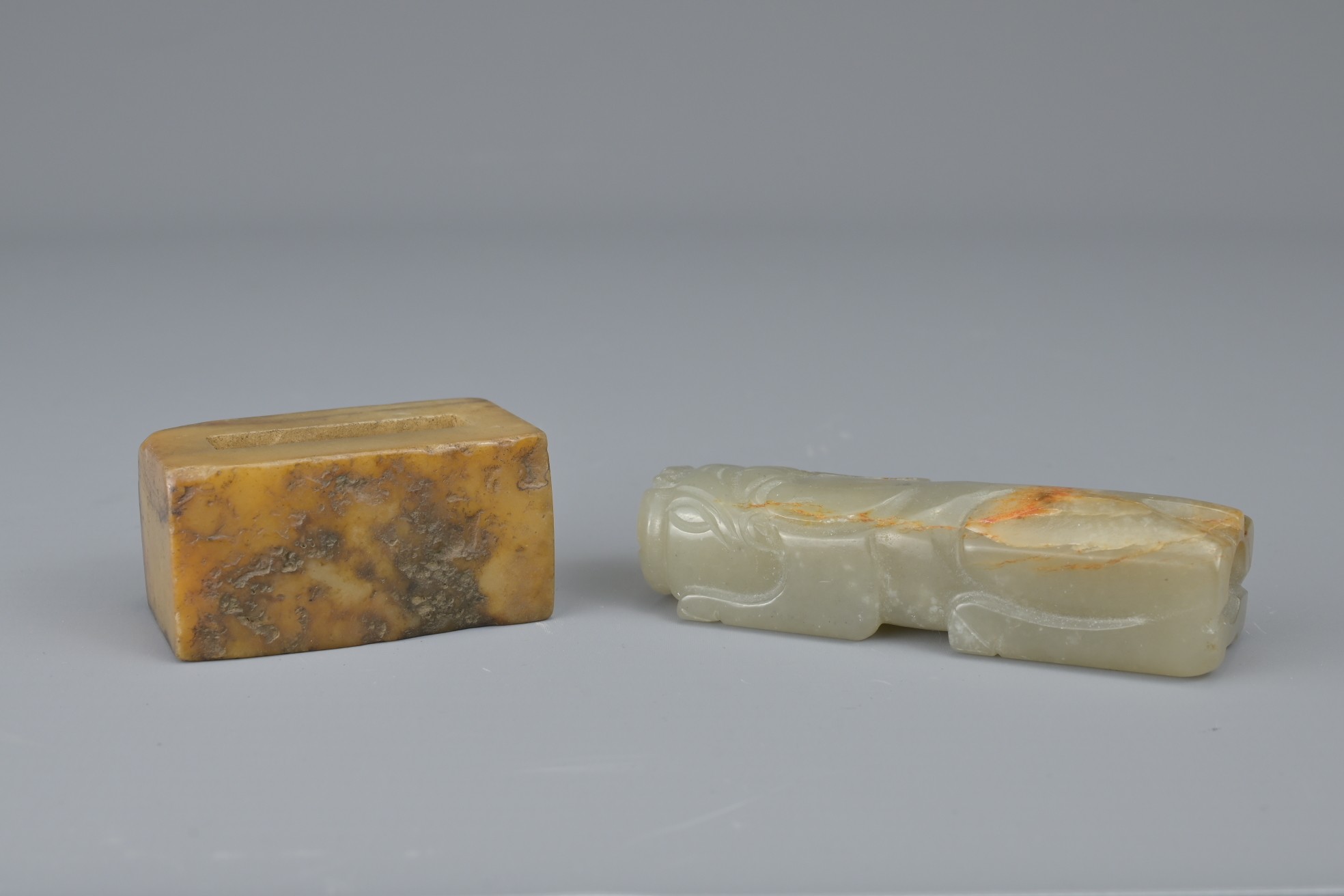 TWO CHINESE JADE FITTINGS. To include a celadon and russet animal form section of cylindrical - Image 4 of 6