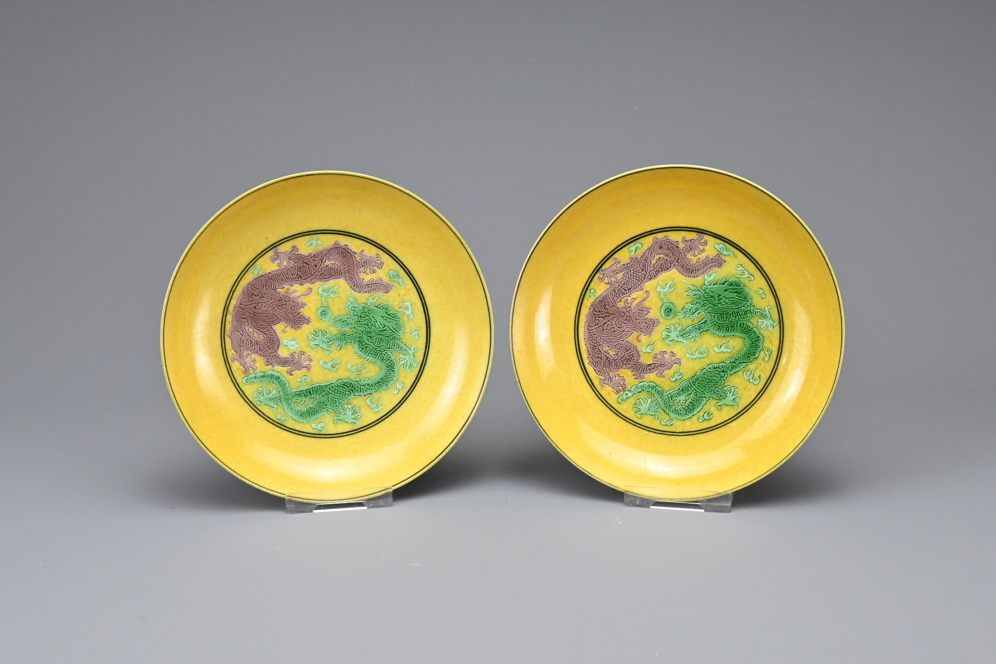 A PAIR OF CHINESE YELLOW GROUND GREEN AND AUBERGINE GLAZED DISHES, GUANGXU MARKS. Each decorated