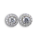A PAIR OF 18KT WHITE GOLD AND DIAMOND CLUSTER EARRING STUDS. The central diamond flanked by a