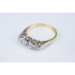 AN 18CT GOLD PLATINUM DIAMOND RING. Four round cut diamonds in a row mounted in platinum setting